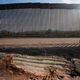 A dead cactus is seen on the ground near the United States-Mexico border wall in Organ Pipe National Park. Construction there has resulted in widespread destruction of natural resources.